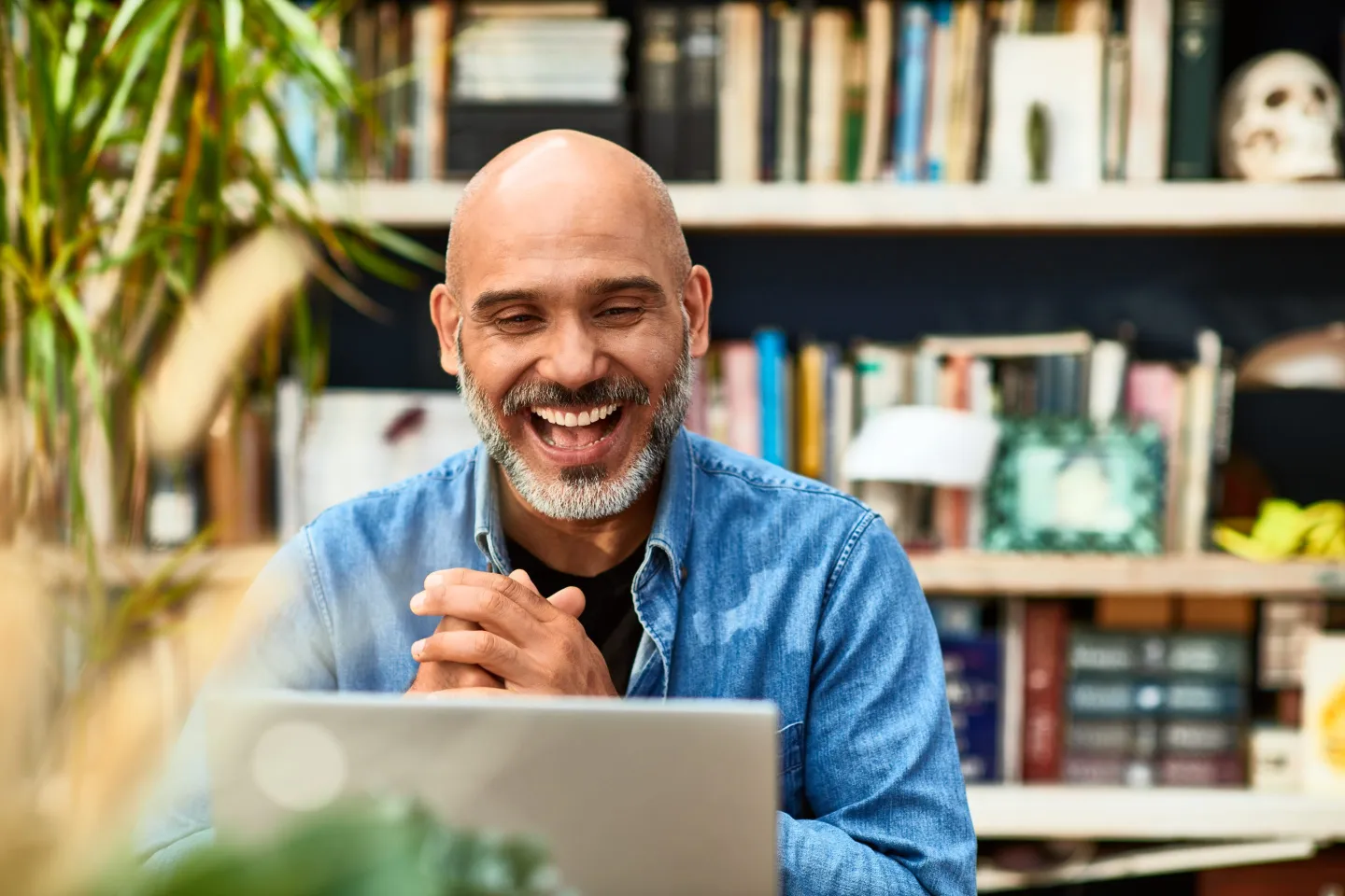 Man laughing at computer