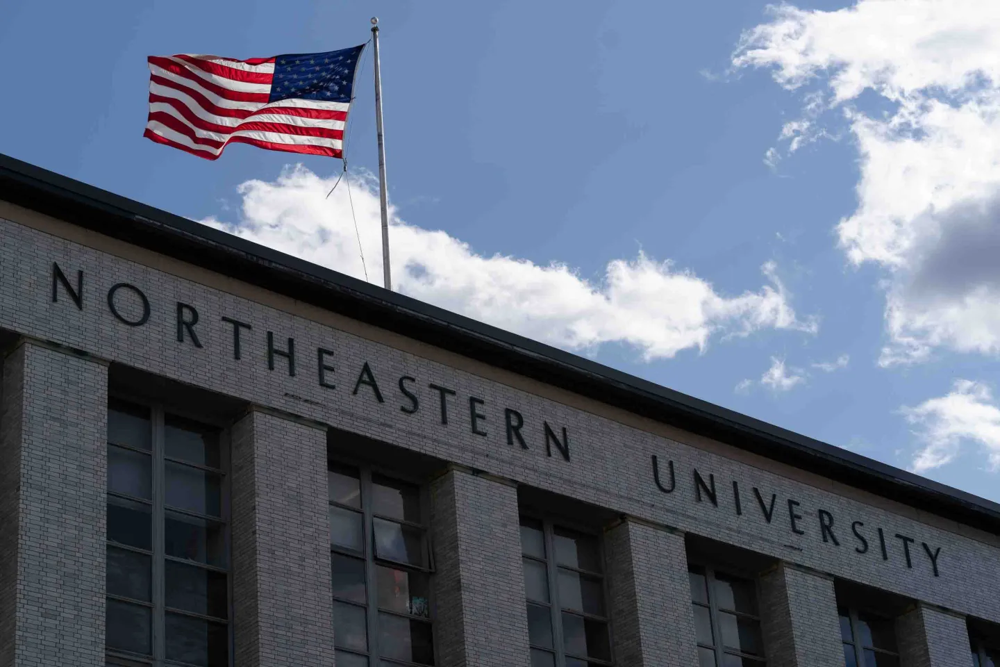 An image of Northeastern University with an American flag.