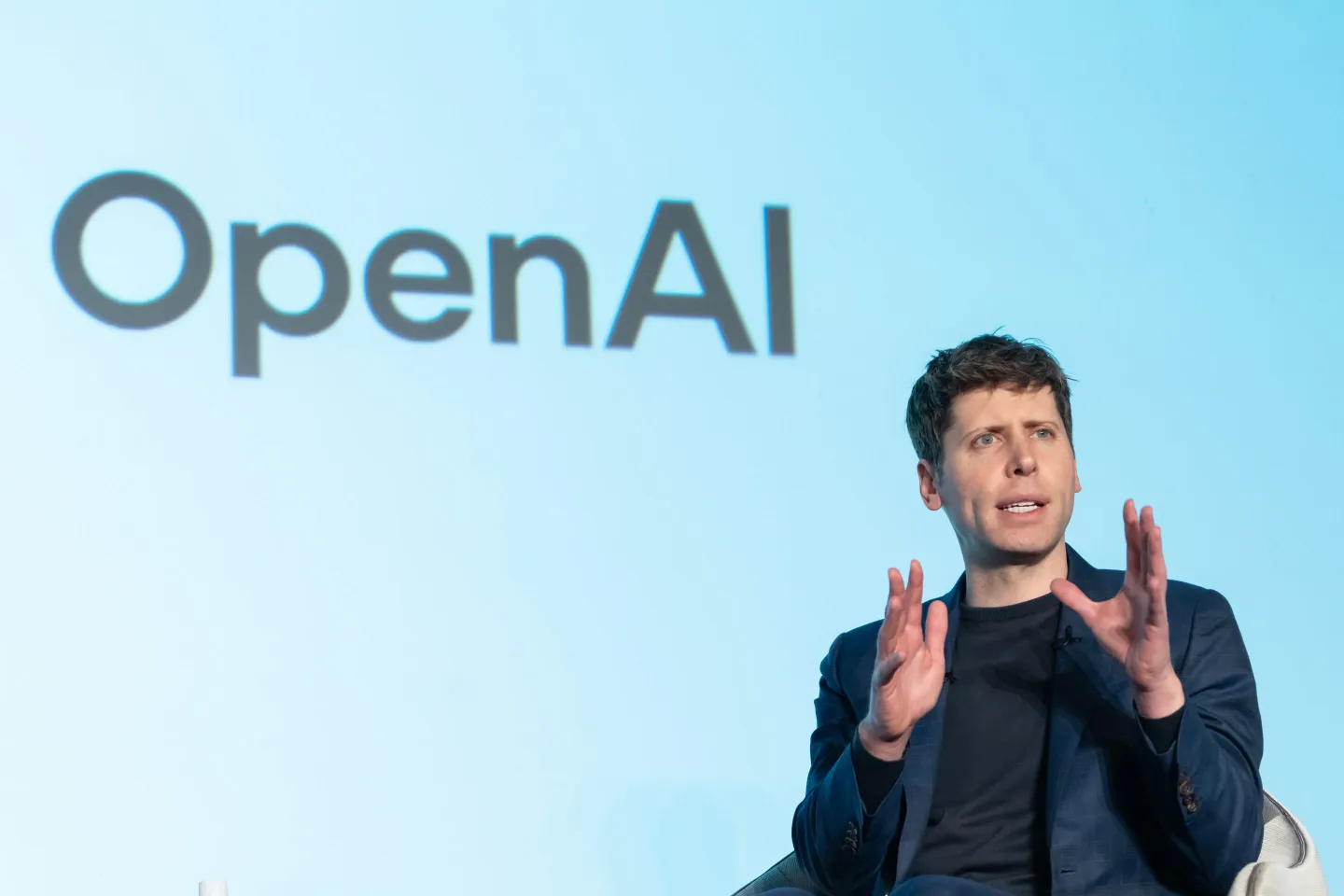 Sam Altman speaking onstage