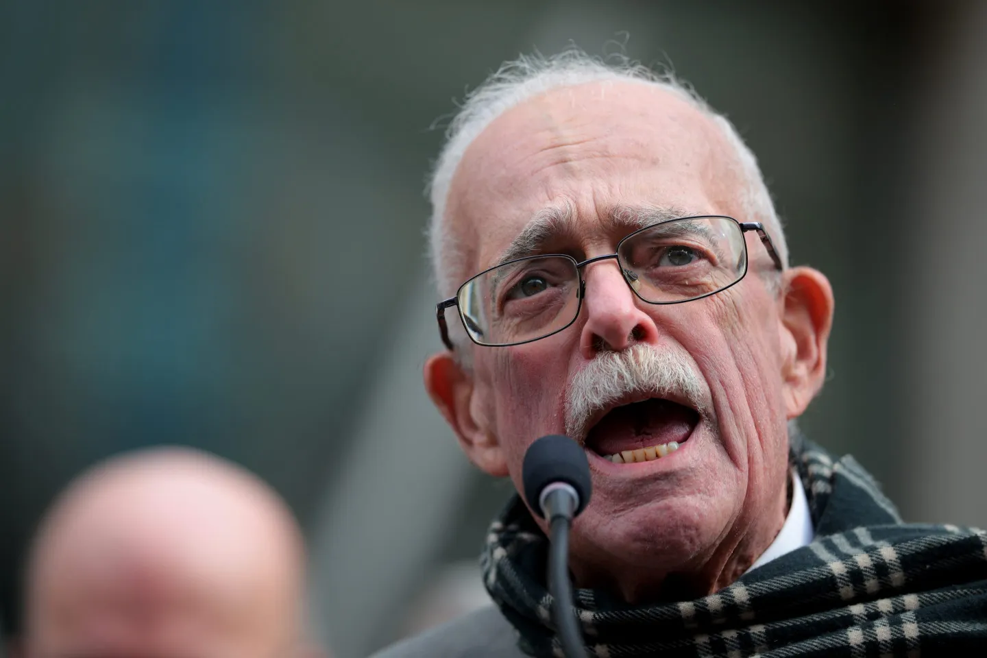Gerry Connolly shouts into a microphone at a rally against Elon Musk and DOGE