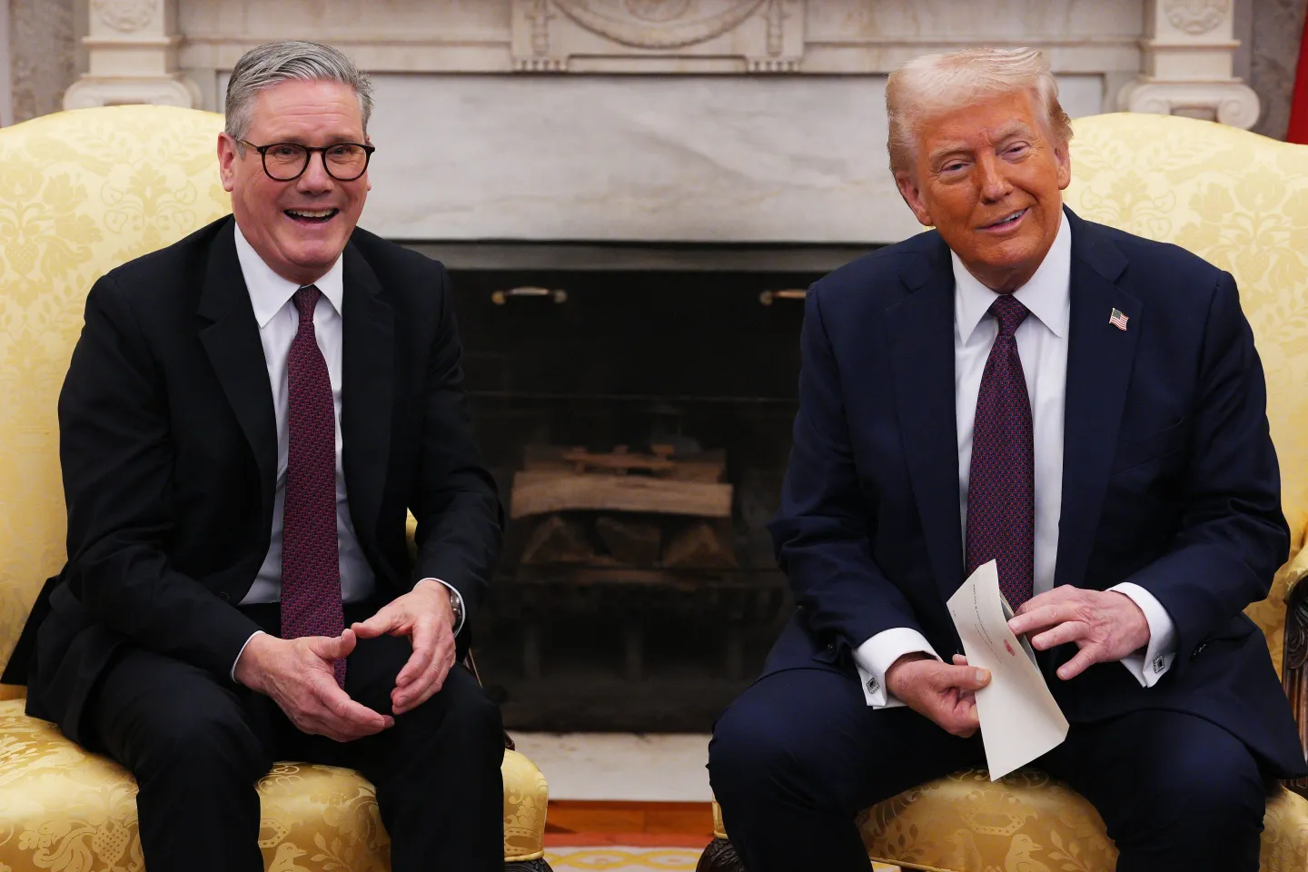 UK Prime Minister Sir Keir Starmer hands an invitation from King Charles III for a second state visit to U.S. President Donald Trump at the White House.