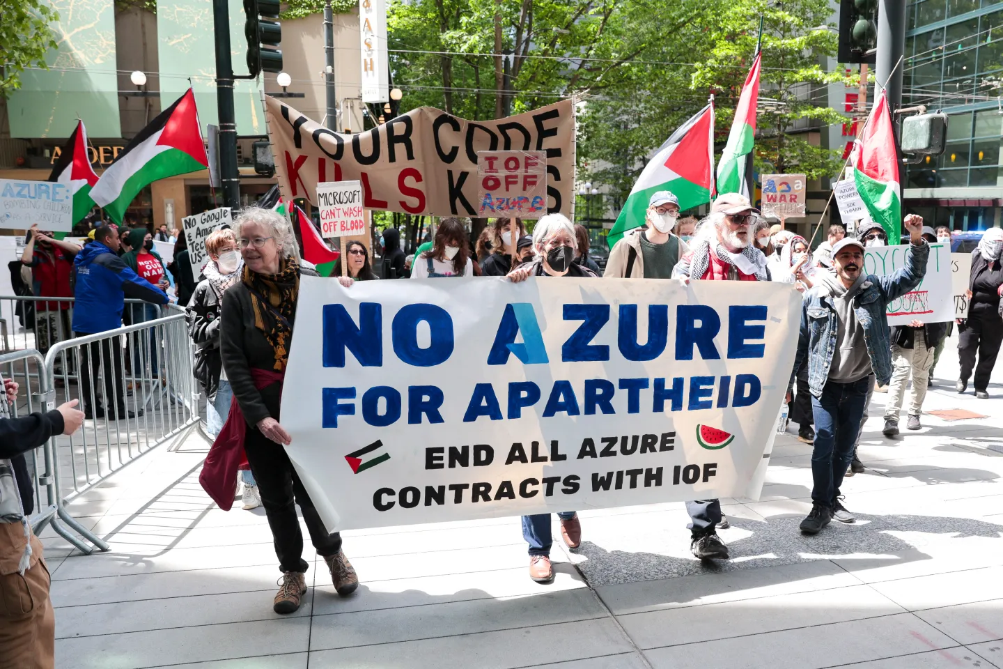 Protesters hold a sign that says No Azure for Apartheid.